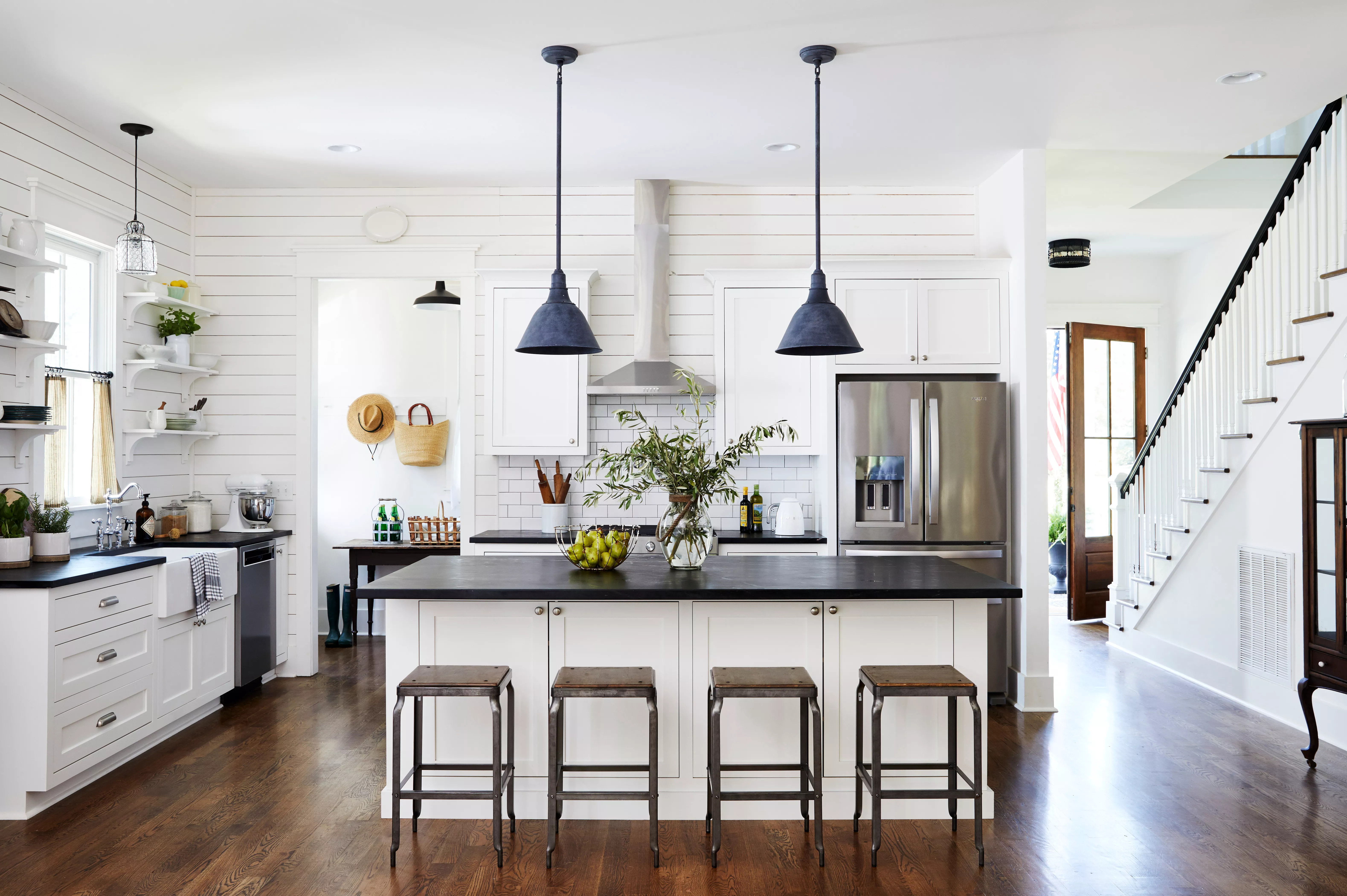 white farmhouse kitchen with shiplap walls and black granite countertops