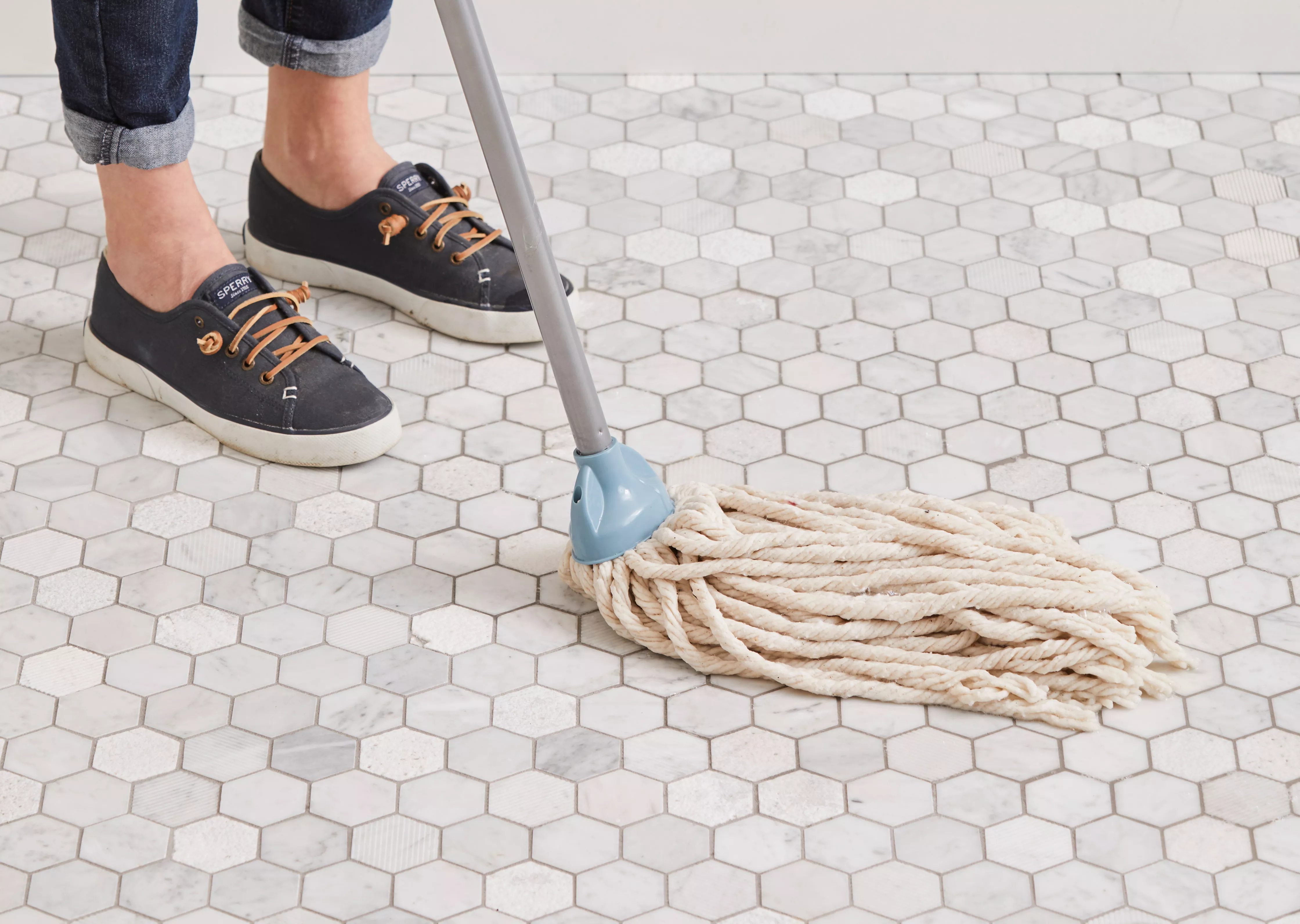 person mopping tile floors